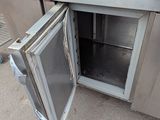 an open door to a stainless steel kitchen with granite counter tops