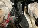 two pairs of shoes that are sitting in a suitcase