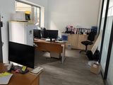 an image of an office with a desk and a refrigerator