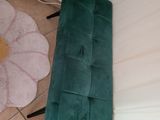 a green couch and a pink chair in a room