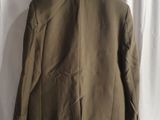 a brown jacket hanging on a white curtain in front of a white curtain