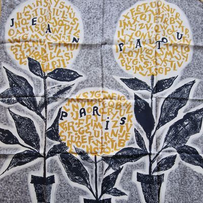 two yellow flowers on a black and white tile
