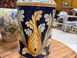 a vase sitting on a table with other vases in the background