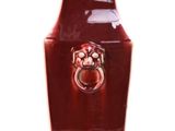 a red vase that has a ring on it