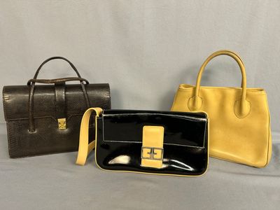 two black and yellow purses sitting next to each other