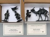 two boxes that have figurines of people in them