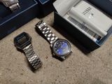 two watches sitting next to each other on a table