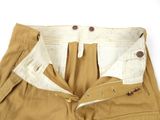 the pants are tan and white with buttons on them