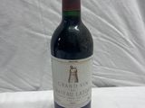 a bottle of wine sitting on a table next to a bottle of wine