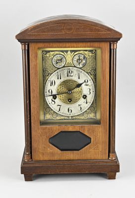 a wooden clock that is sitting on a white surface