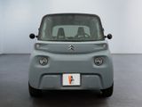 a small grey car that is parked in a room
