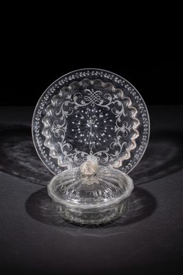 a close up of a glass plate on a table with a black background