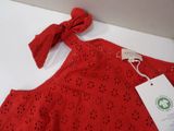red dress with a bow on the neck and a tag on the back