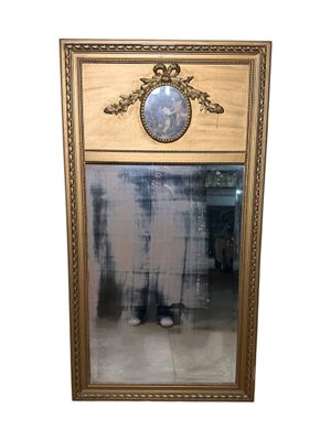 a mirror with a picture of a man standing in front of it