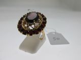an image of a ring with a garnetite stone