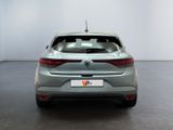 the rear end of a grey car in a white room