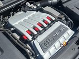 the engine of a car with its hood open on the street