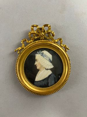 an old picture of a woman in a black dress with a white hat