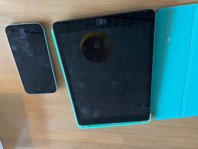 two cell phones sitting on a table next to each other