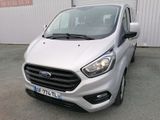 ford transit van parked in front of a building in a parking lot