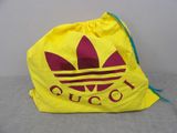 yellow bag with red logo on it sitting on top of a couch