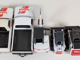 a lot of toy cars and trucks that are on the table