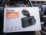 someone holding a box with a camera attached to it in a car