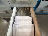a drawer full of papers in the middle of a room