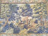 a tapestry with a picture of a forest scene on it