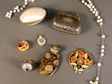 a lot of jewelry that is laying out on the table