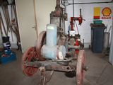 an old fire hydrant in a garage with a lot of tools