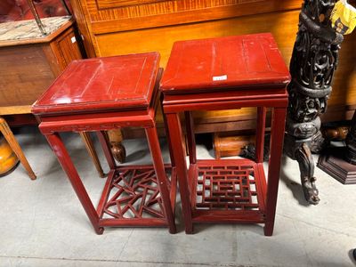 two red tables sitting next to each other on the floor