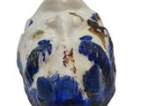 a blue and white vase with a mountain in the background