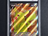 the pokemon card is in a plastic case on a black surface