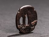 a small metal object with a bird on it