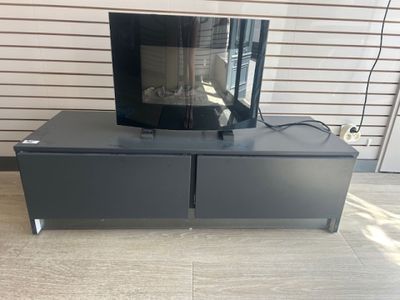 a television sitting on top of a table in a room