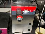 an image of a coffee machine with a cup next to it