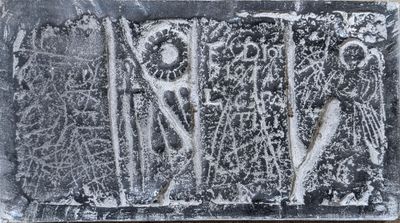 a black and white photo of a stone plaque with carvings on it