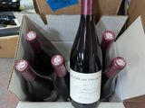 many bottles of wine in a cardboard box on the floor