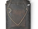 a wooden frame with a heart on it on the wall