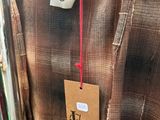 a brown shirt hanging on a rack in a store