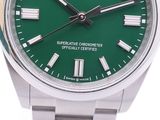 the green dial of a rolex watch with roman numerals