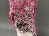 a close up of a pink shawl on a mannequin head