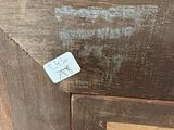 a close up of a piece of wood with a tag on it