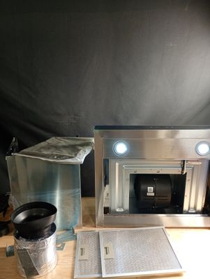 a microwave and a cup on a table with a black background