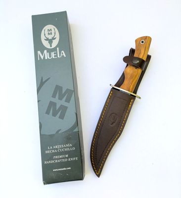 a knife that is laying on the table next to a box