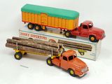 two toy trucks that are sitting next to each other