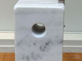 a white marble block with a hole in the middle of it