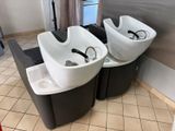 two sinks that are sitting on the floor in the bathroom