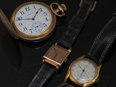three different types of watches on a black surface